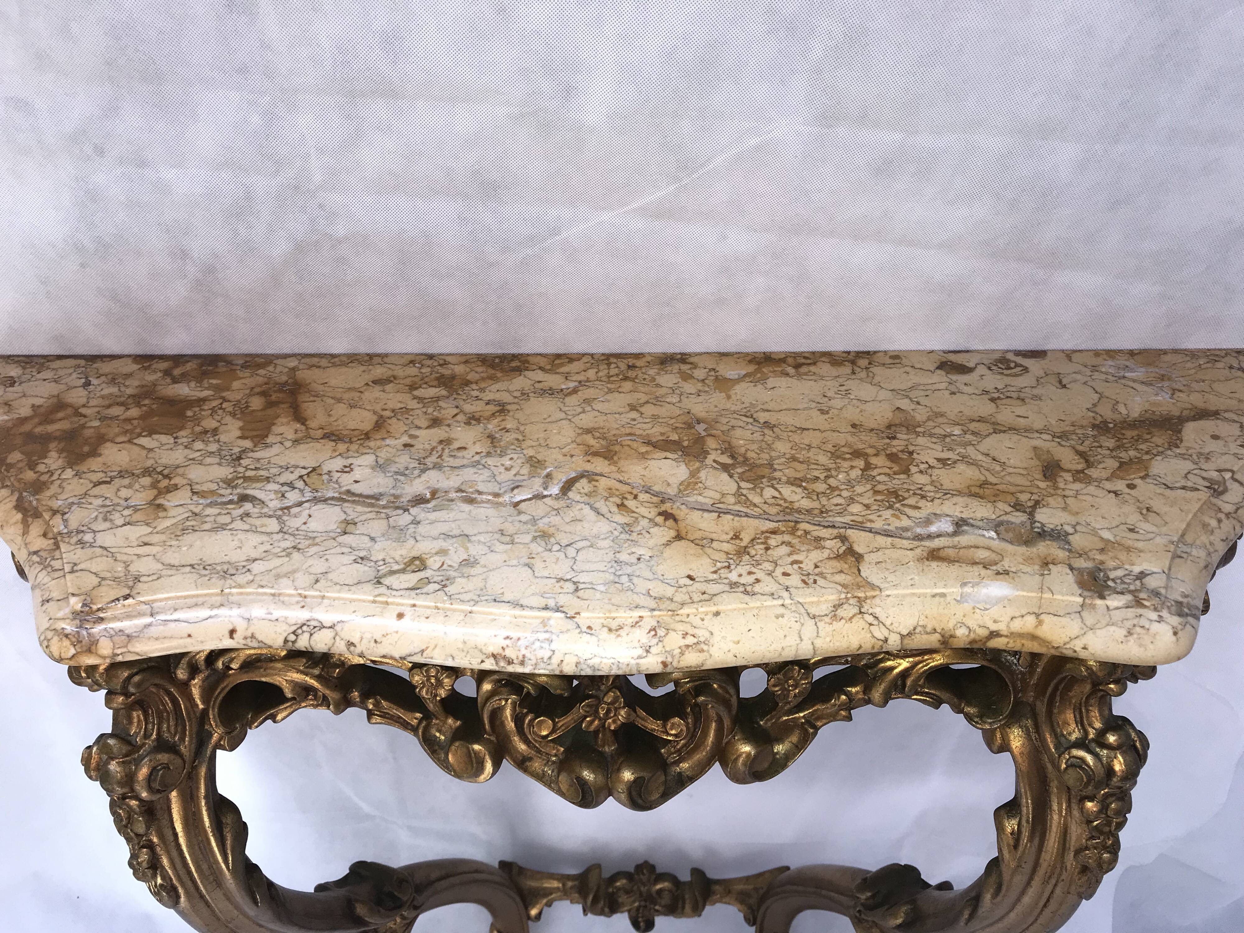 Golden console with marble in Louis XV style.