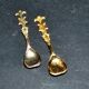 Set of 2 vintage gold metal salt spoons.