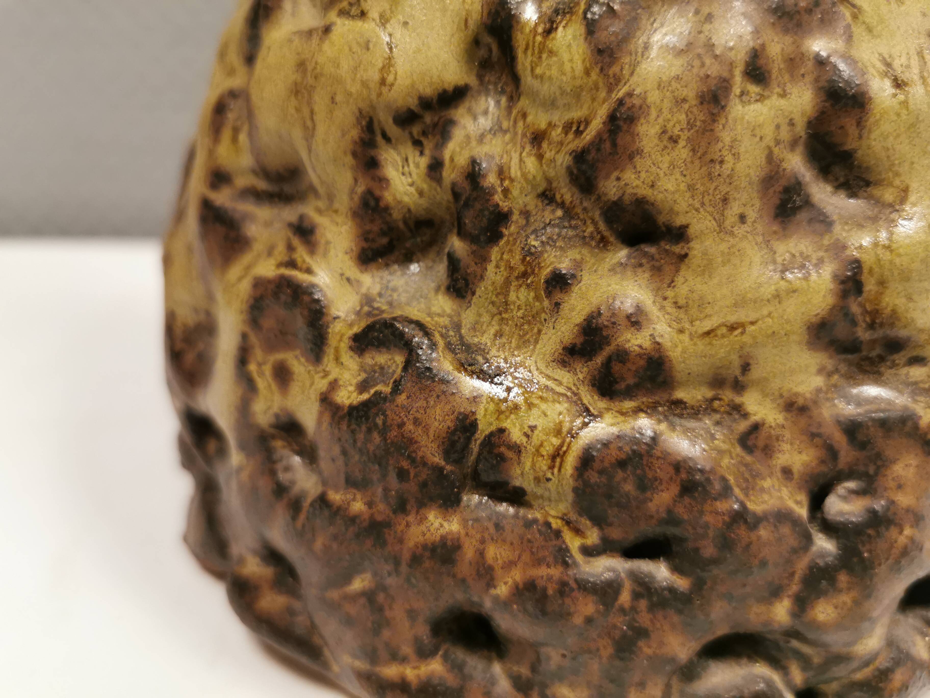 Ceramic table lamp, in greenish/brownish glaze, almost in the shape of a volcano.