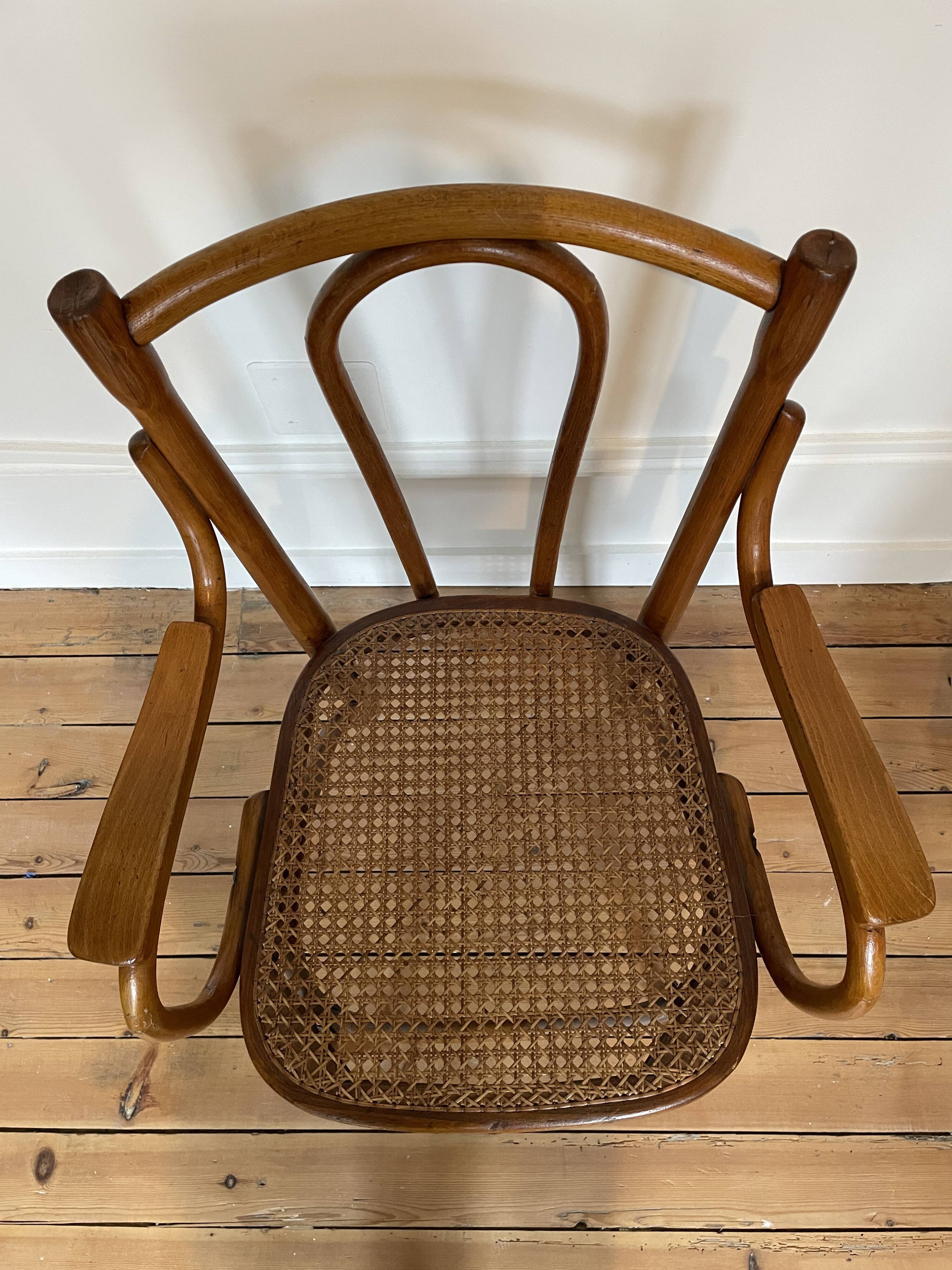 Old thonet armchair in curved wood and rattan cane