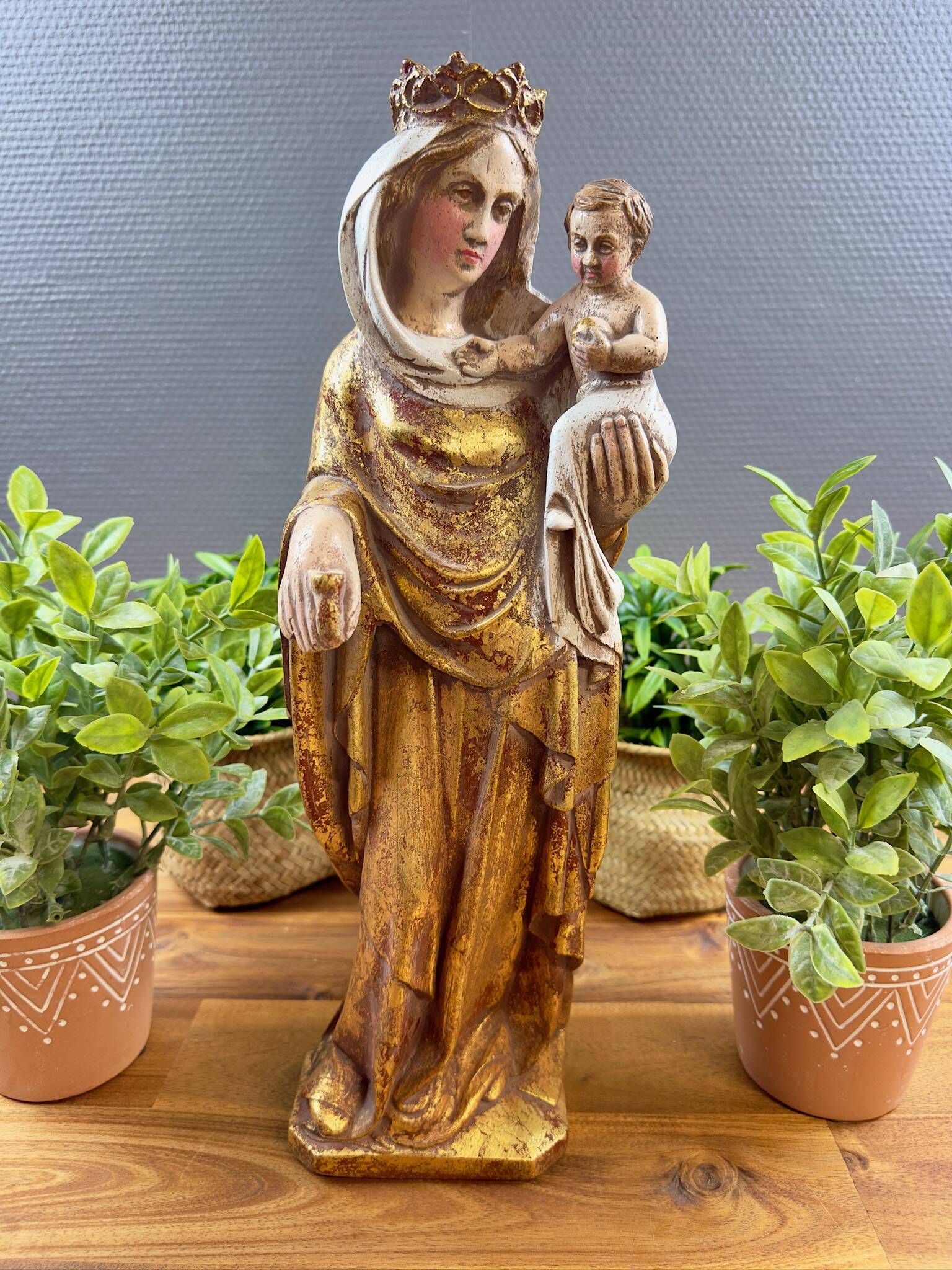 Statue of the Virgin holding the Child Jesus in polychrome terracotta.
