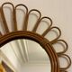 Old vintage asymmetrical round rattan mirror
