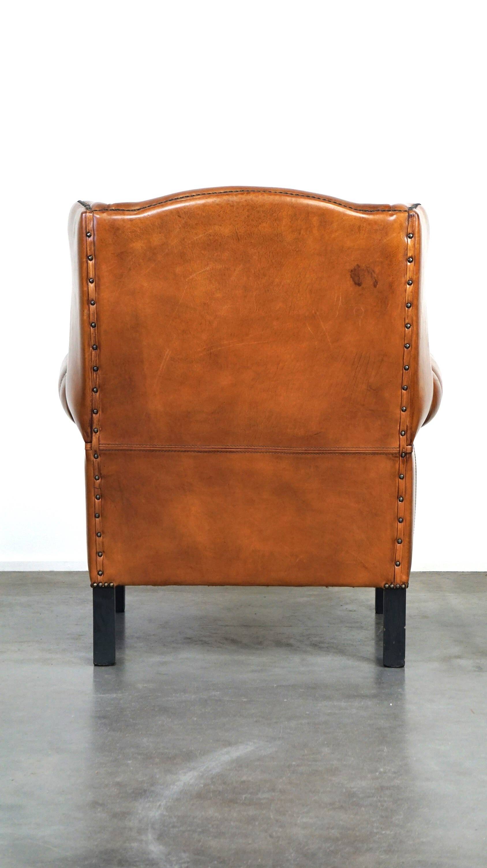 Très beau fauteuil à oreilles en cuir de mouton avec des détails époustouflants