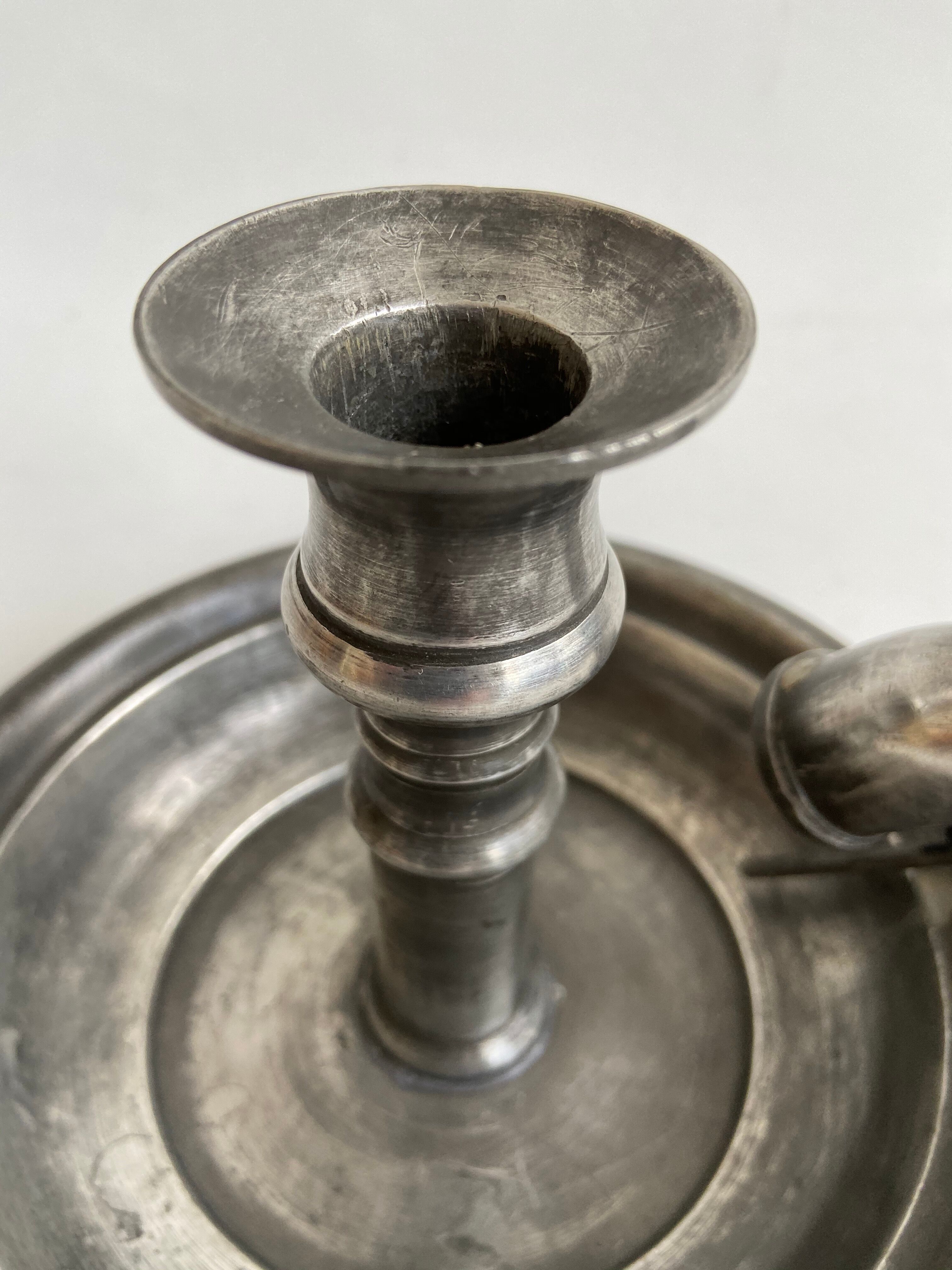 Tin candlestick with extinguisher