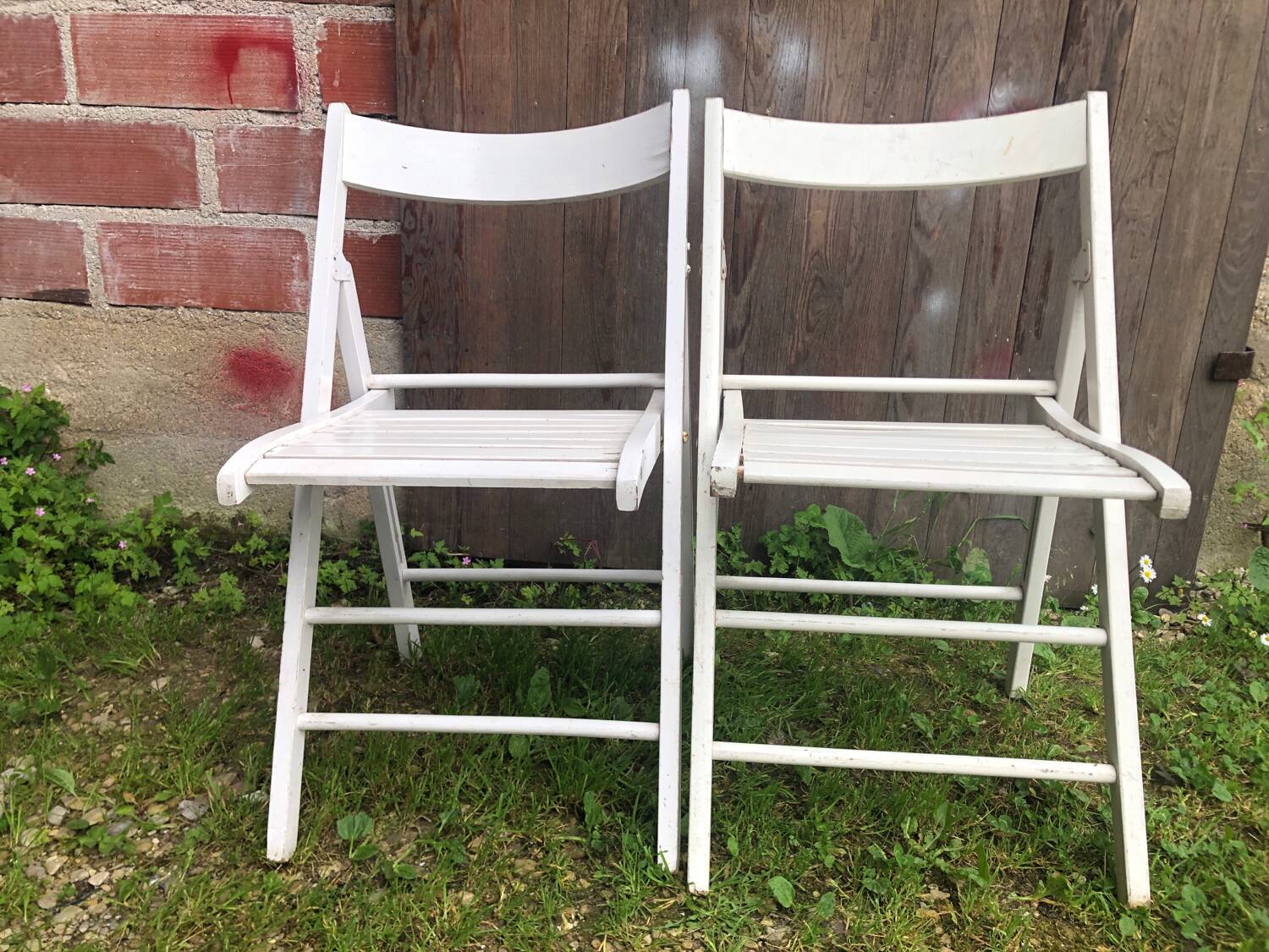 Pair of vintage white wooden folding chairs