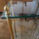 Elegant wheeled serving trolley in gilded brass and glass, in a spirit