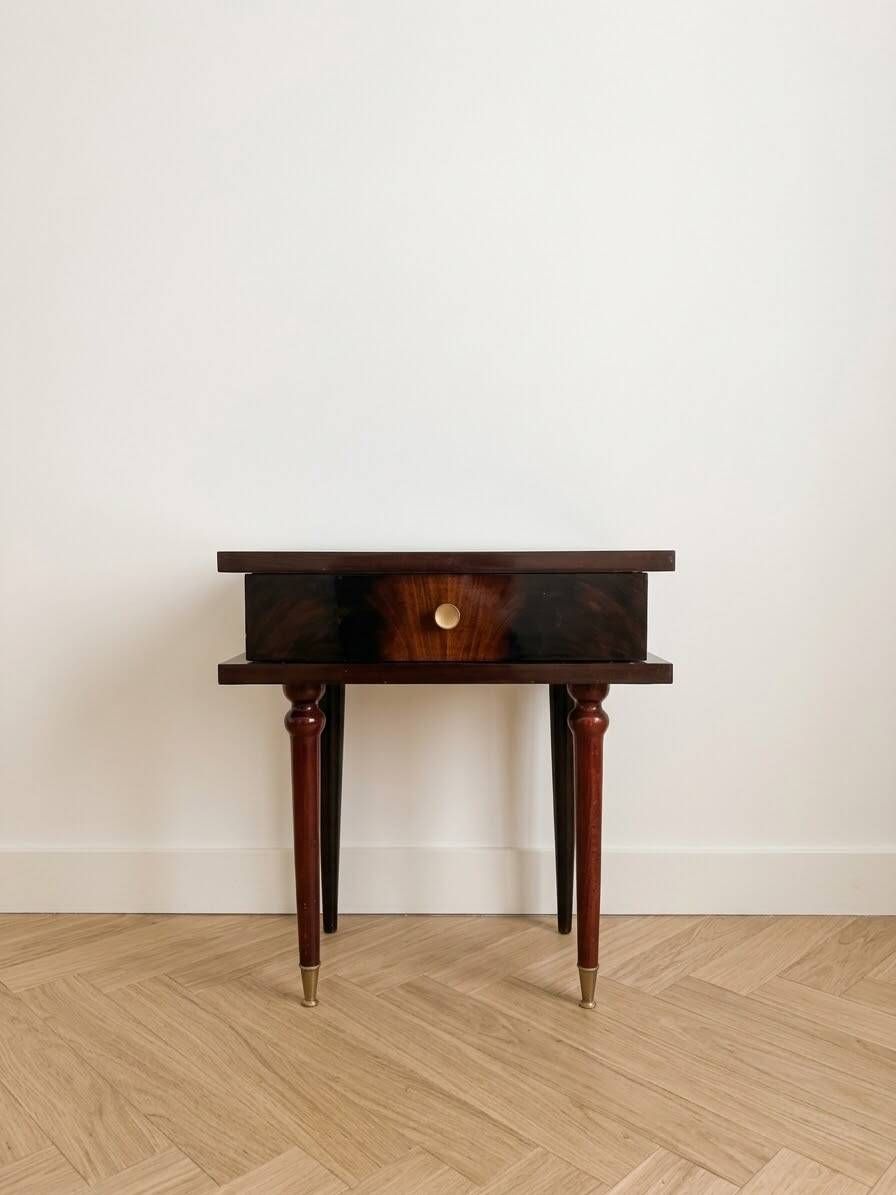 Vintage Art Deco bedside table in dark wood with gold details.