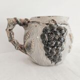 Pitcher bunches of grapes in relief