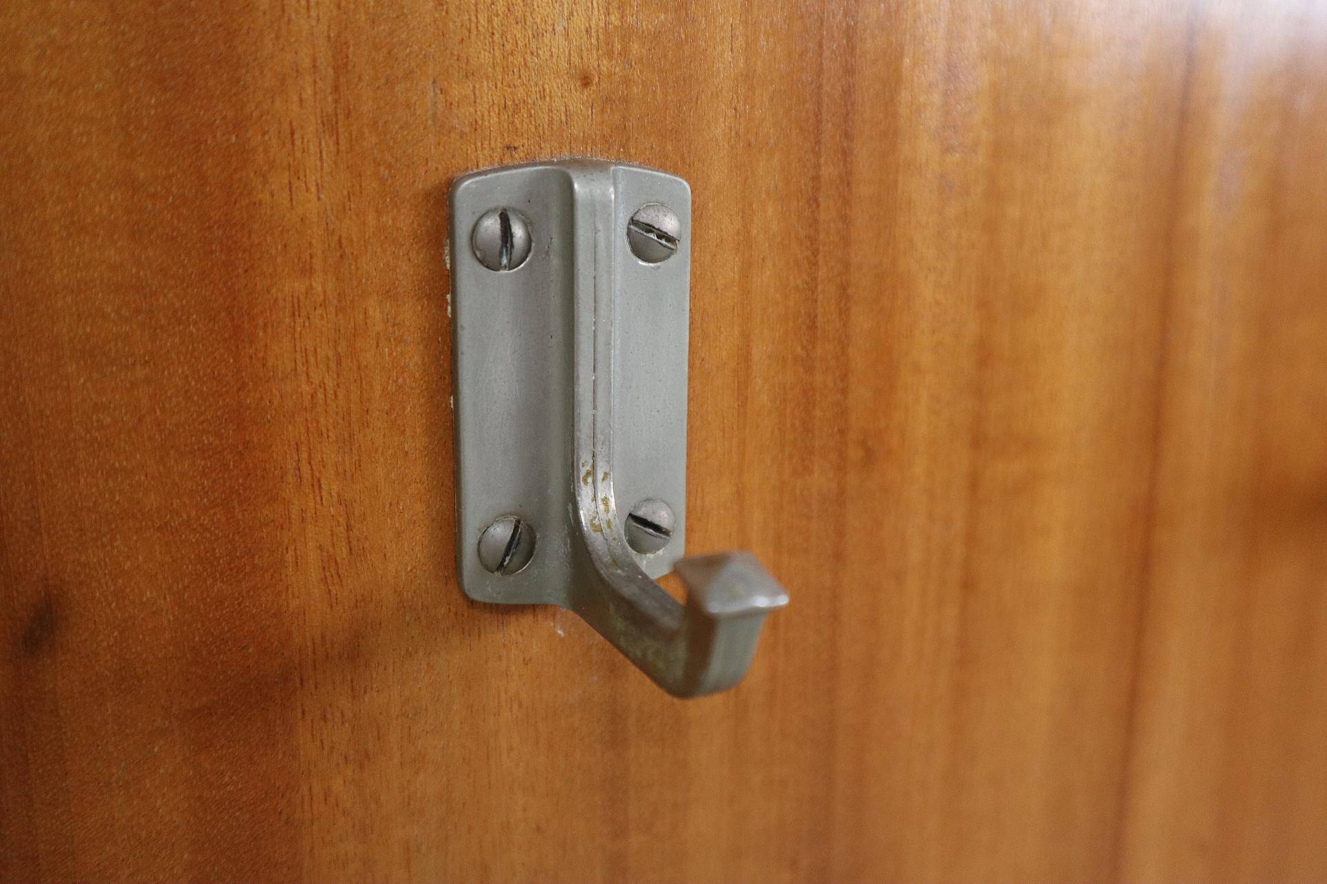 Modernist wall-mounted cloakroom in teak