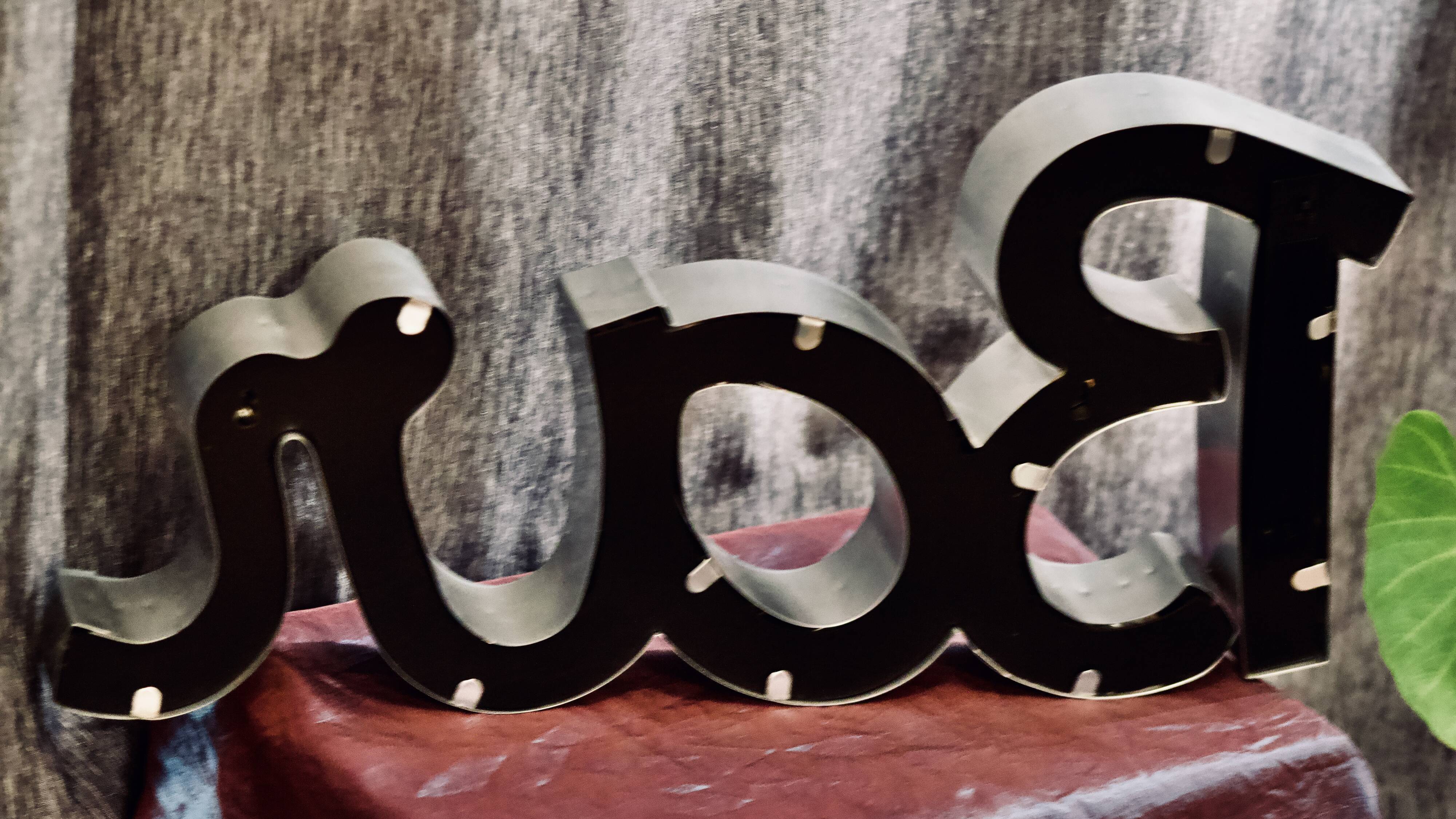 Ancient Light Sign in aluminium lettering forming the word "BAR"