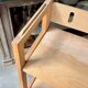 Folding bookshelf in light wood.