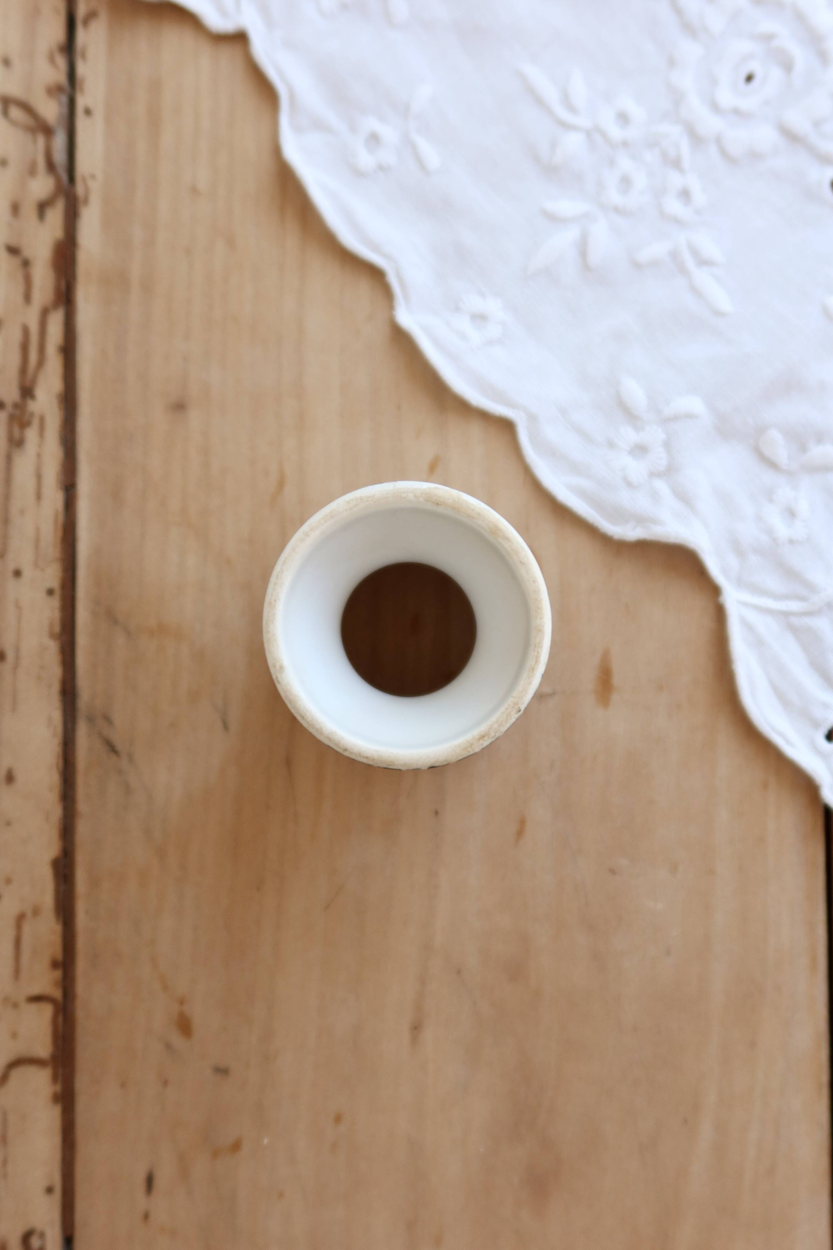 Old diabolo egg cup, ironstone with ivory and green pattern.