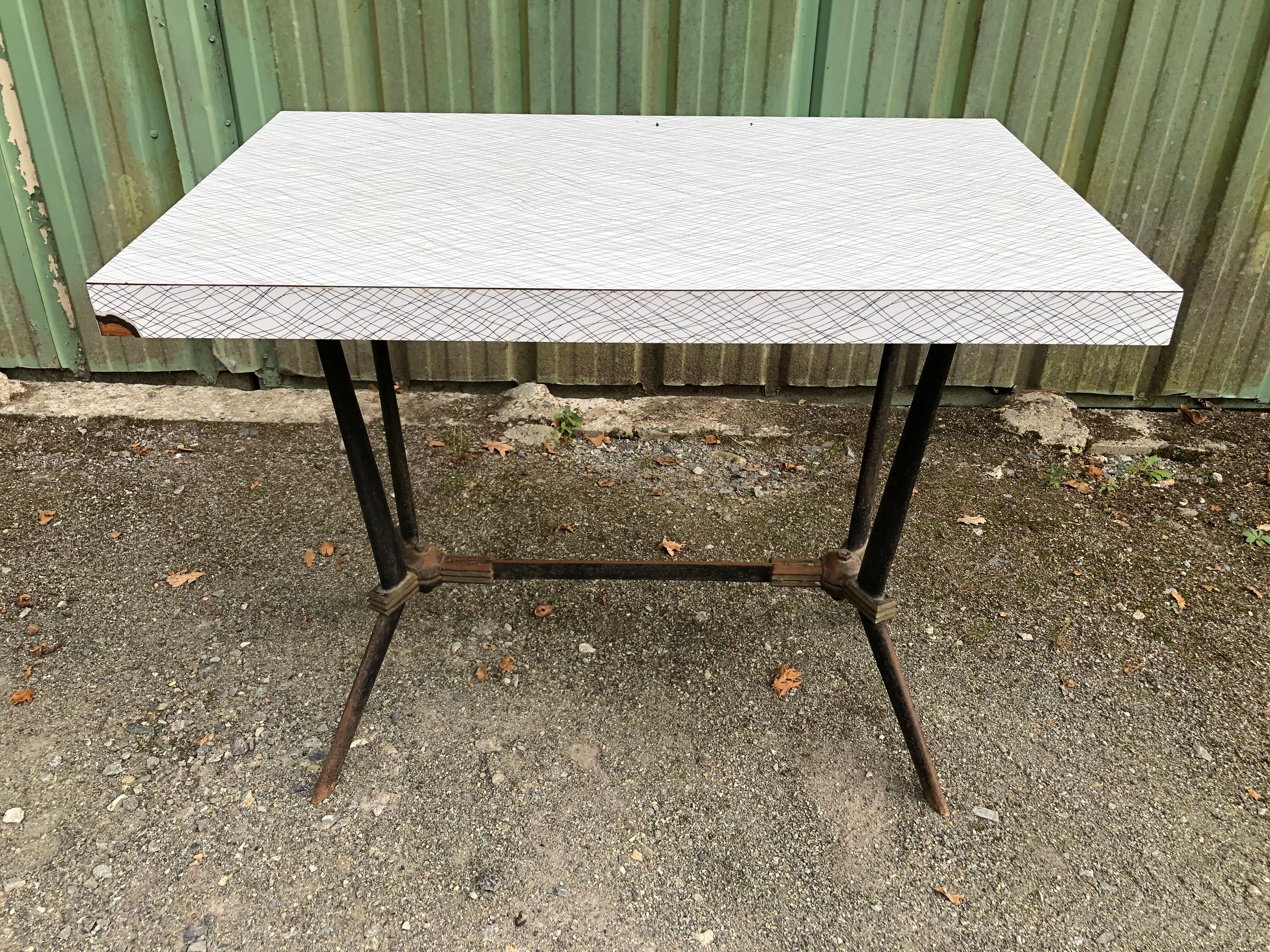 Vintage bistro table with an Art Deco style cast iron base and Formica top.