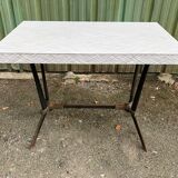 Vintage bistro table with an Art Deco style cast iron base and Formica top.