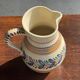 Beige carafe with stylized blue flower friezes