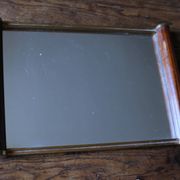 Rectangular mirror tray with wooden handles and gilding.