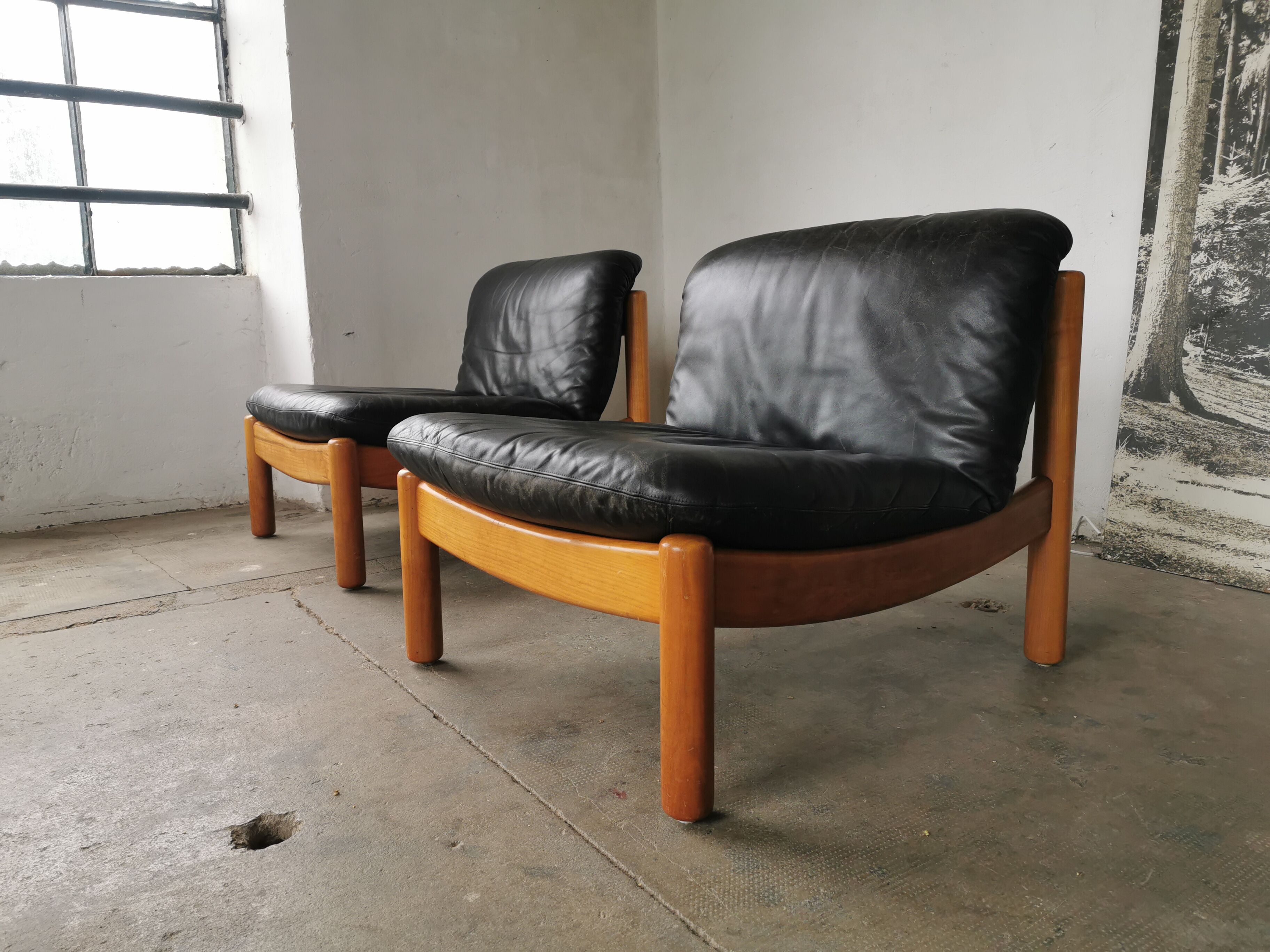 Pair of designer leather armchairs 80s
