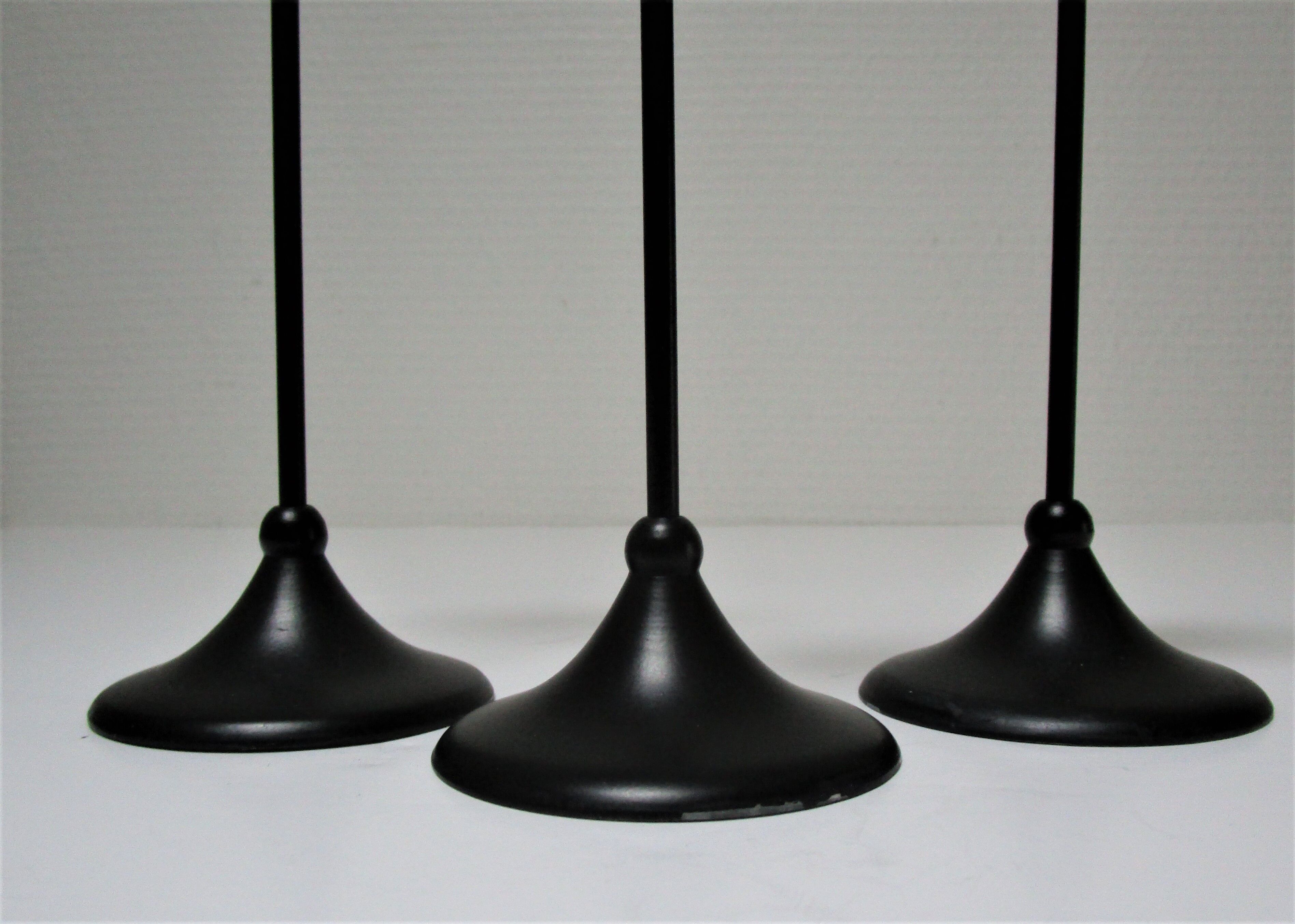 Three Scandinavian black lacquered metal candle holders