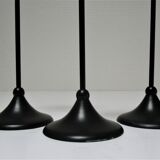 Three Scandinavian black lacquered metal candle holders