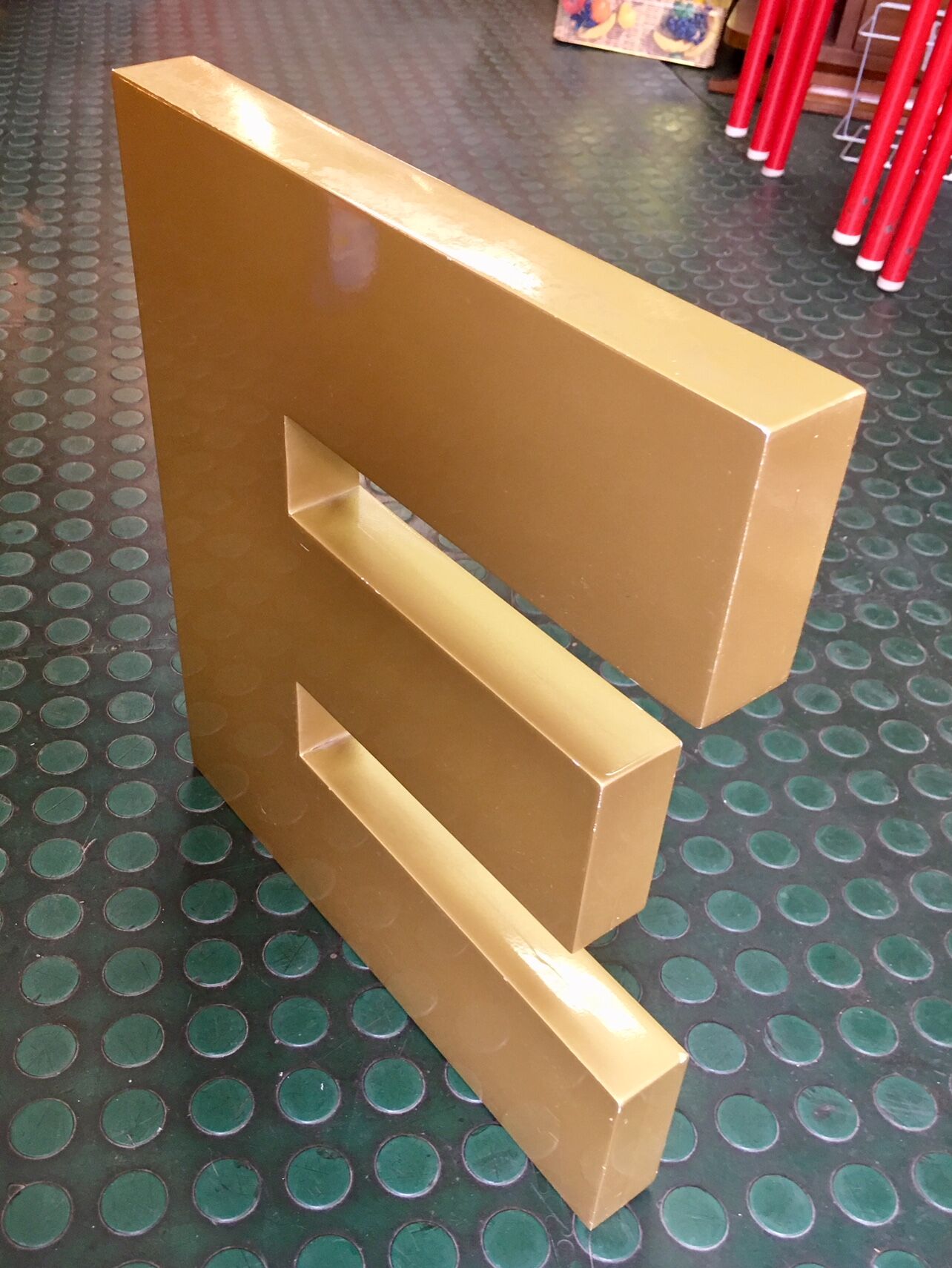 Golden sign letter E