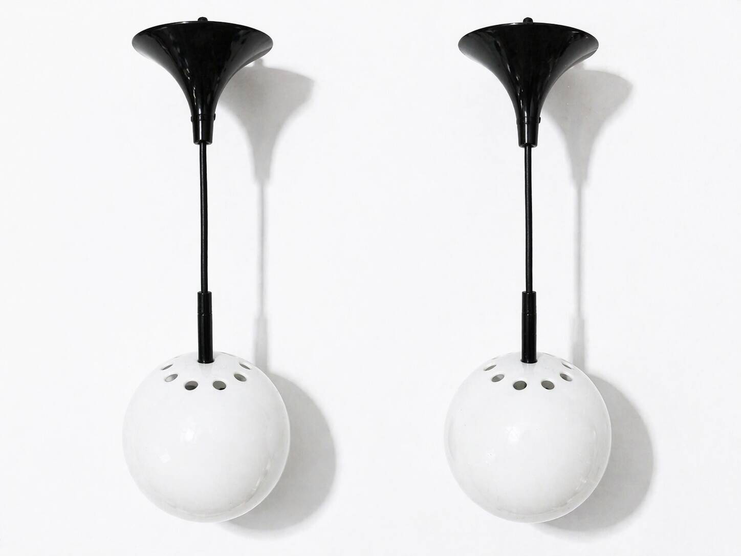Two white metal globe pendant lights, 1970s.