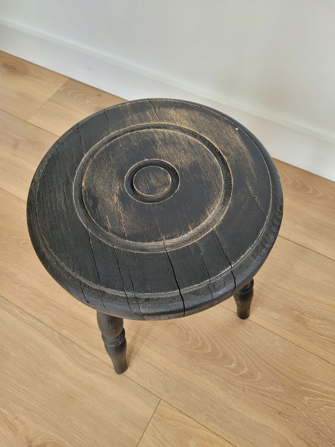 Black wooden tripod stool