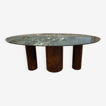 Verde Alpi marble dining table and rusty steel cylinder legs.