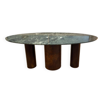 Verde Alpi marble dining table and rusty steel cylinder legs.