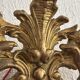 Antique rococo mirror with putti, gilded carved wood and stucco frame, 19th century.