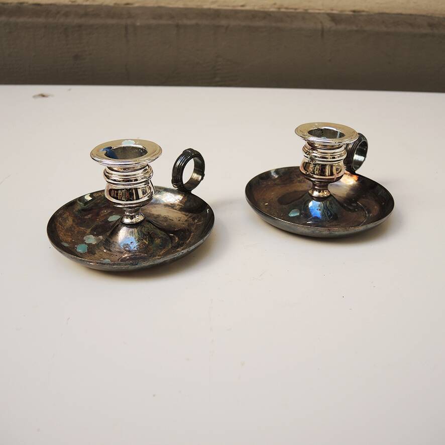 2 antique metal candlesticks with handles