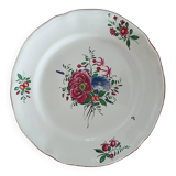 Ancien plat rond en faïence de l’est, motif floral