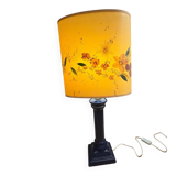 Corinthian column lamp base in blue with a lampshade of dried flowers.