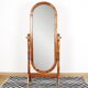 Large psychic mirror on legs with pivoting oval frame.