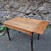 Vintage pine table with drop-leaf extension and turned beech legs, France, 1930s.