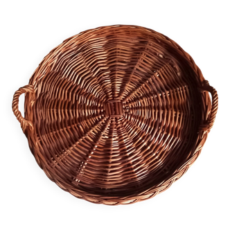 Large round dark wicker tray with two handles.
