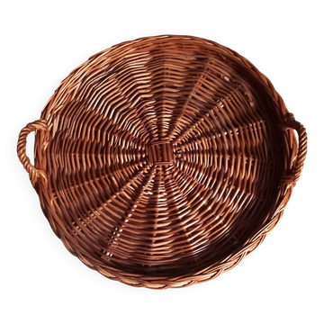 Large round dark wicker tray with two handles.