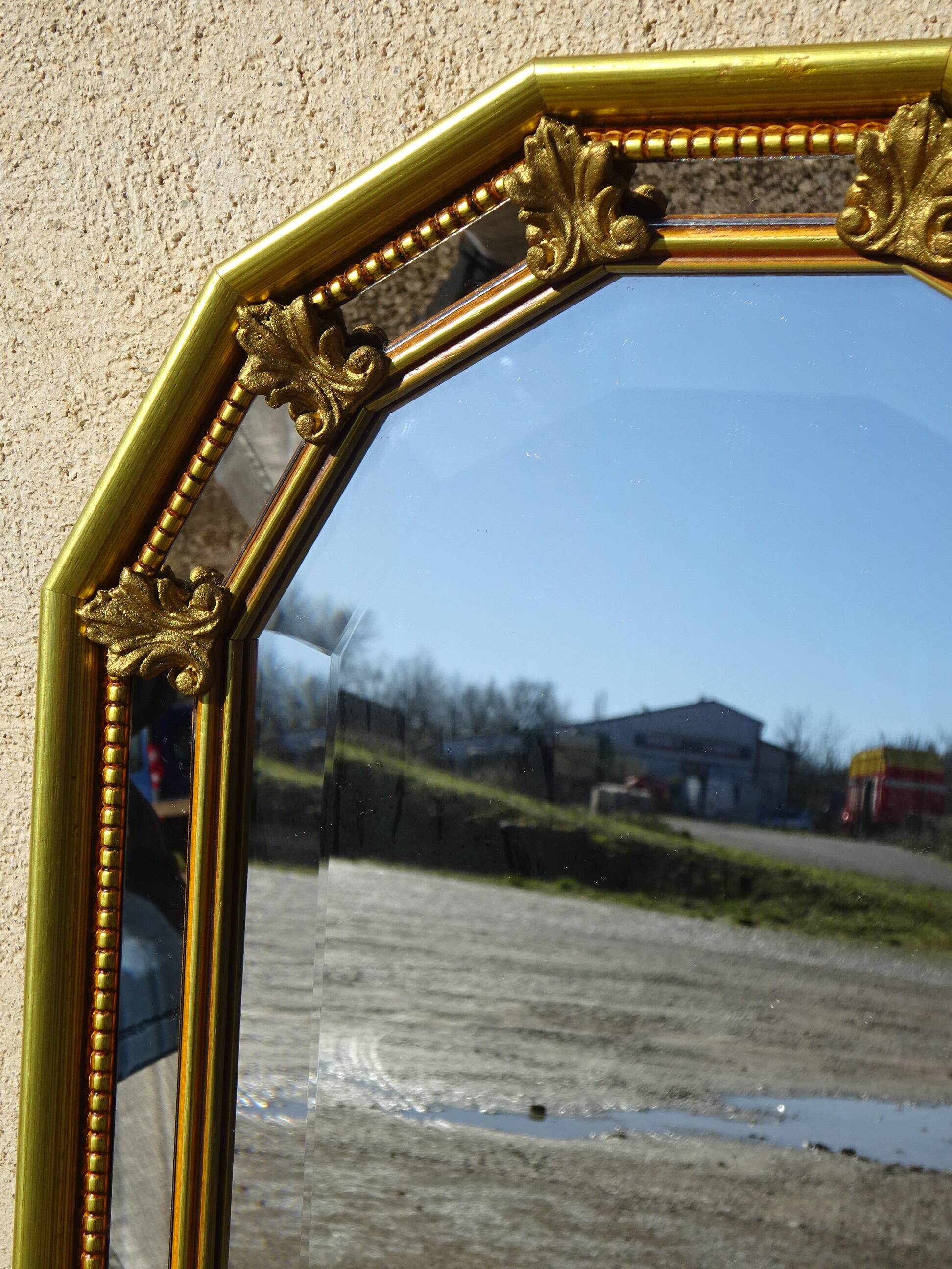 Hall mirror, gilded frame with fillets and fleur-de-lis.