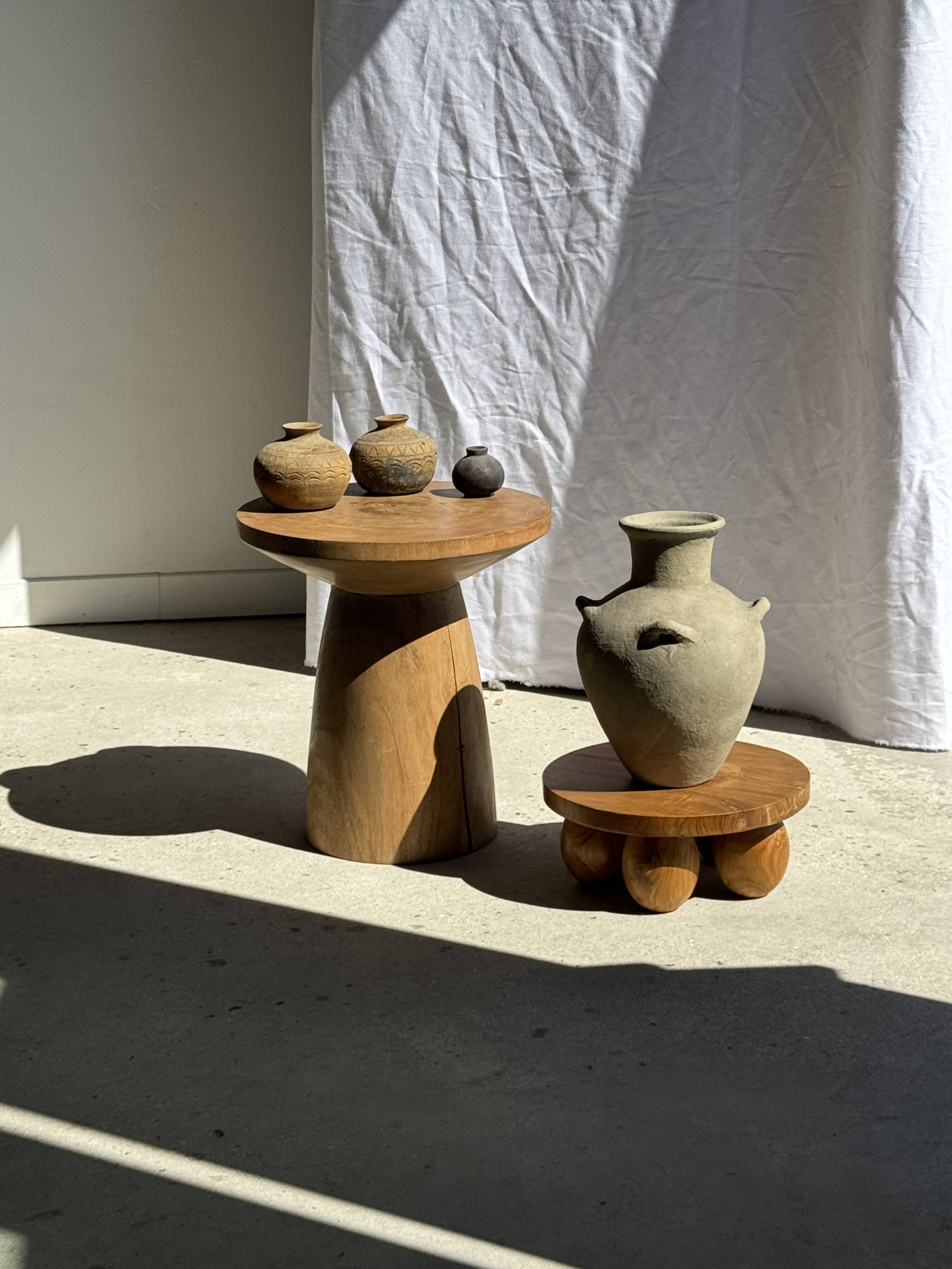 Natural solid mango side table (monoxyle) with conical legs.