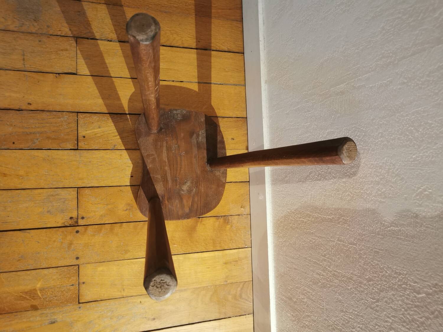 Old wooden tripod bench stool milking shepherd’s bench