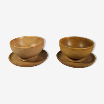 Two sandstone bowls and saucers