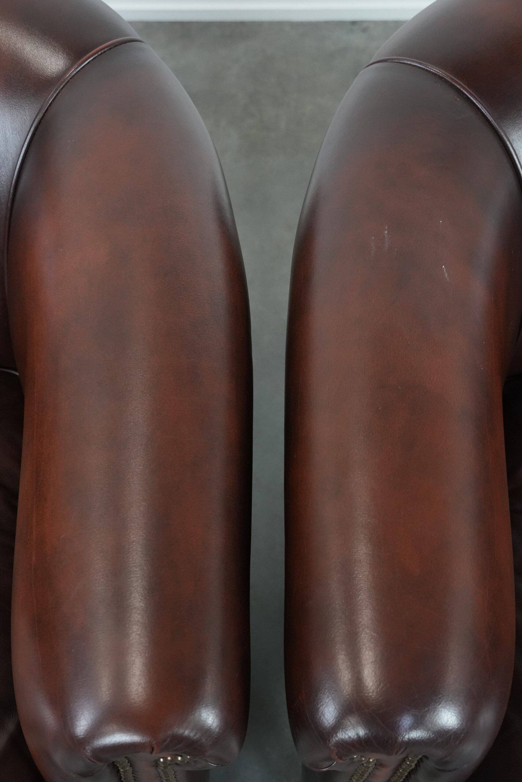 Set of two cow leather club armchairs in a luxurious red/brown colour