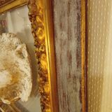 Antique gilded frame with stone lion head ornament on plexiglass