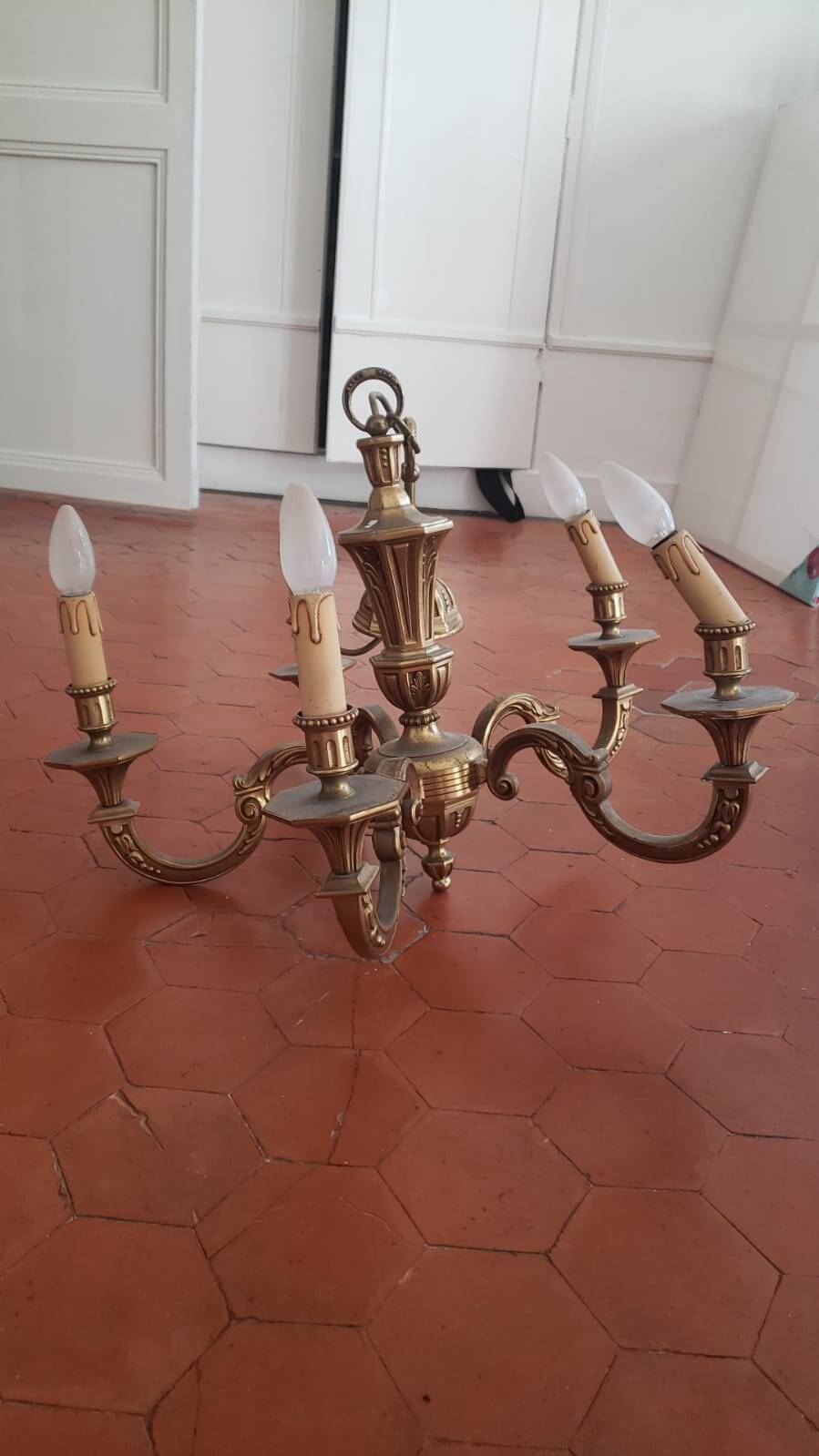 Large old chandelier in gilded brass