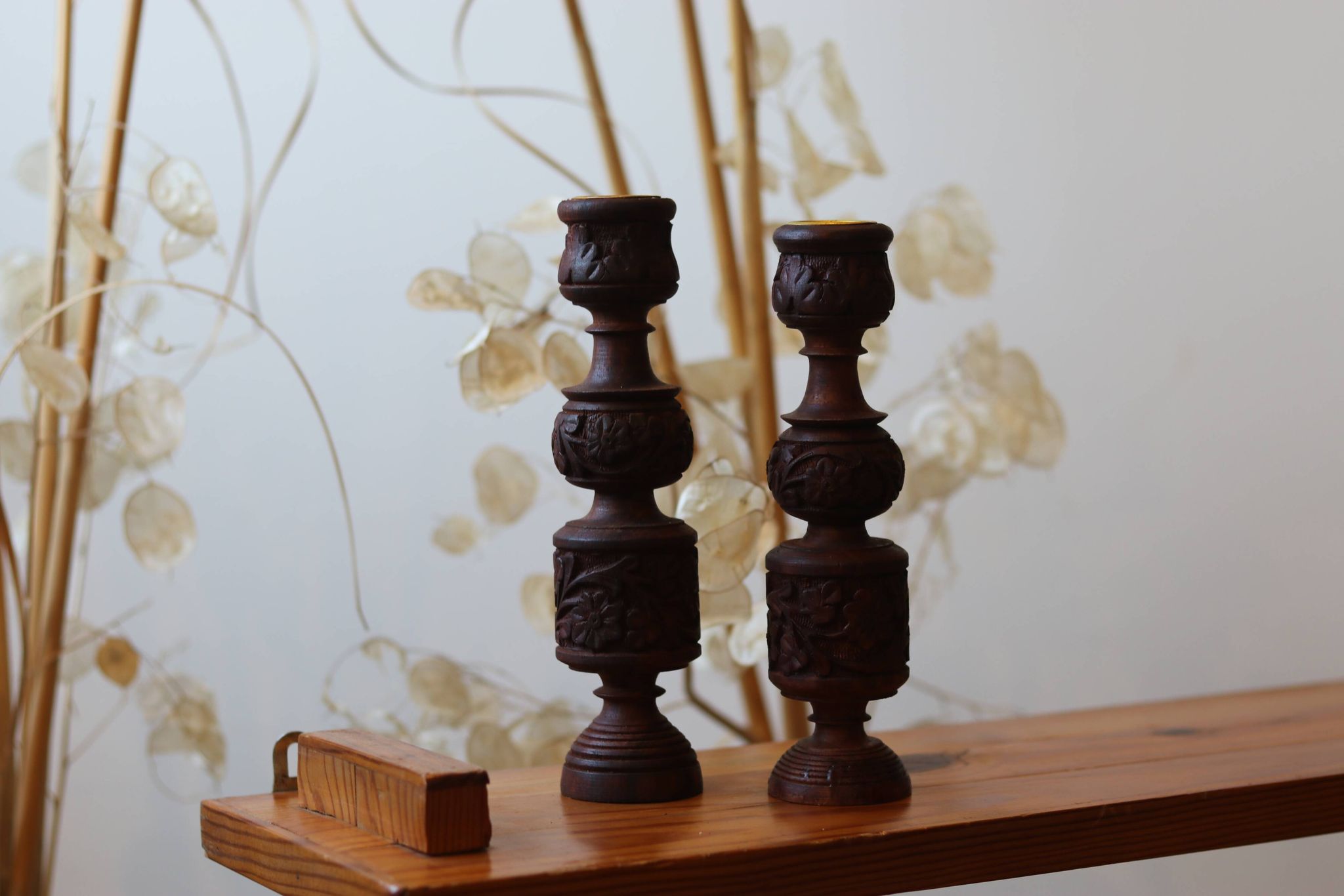 Pair of turned and carved wooden candlesticks