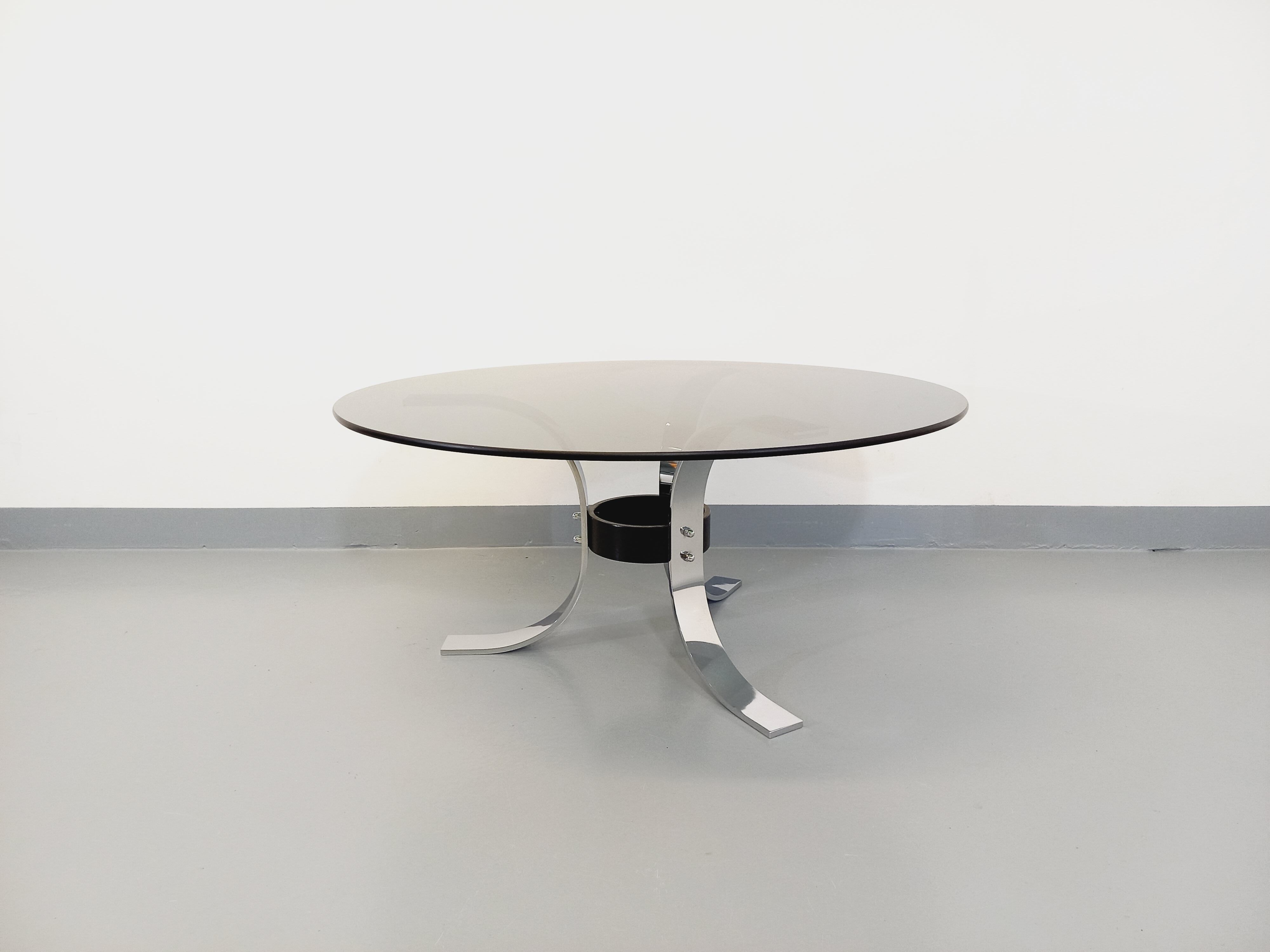 Vintage round coffee table in glass, chromed metal and black metal Space Age style of the 70s
