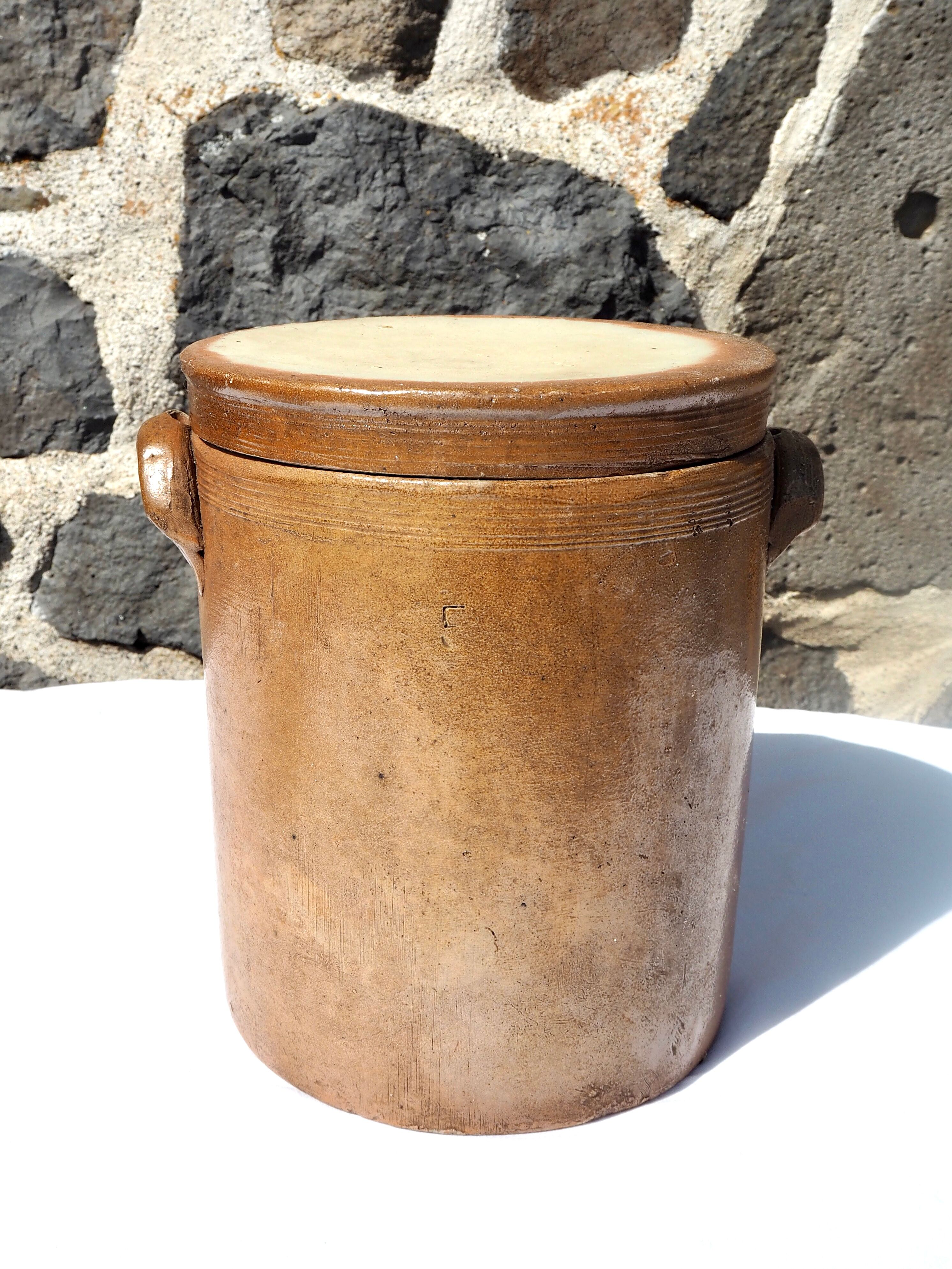 Trio of stoneware pots with lids