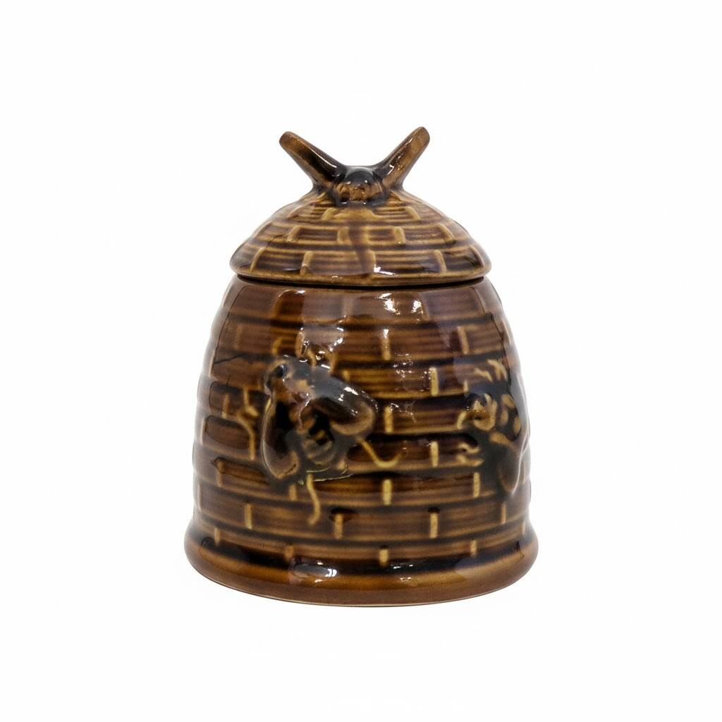Honey pot in the shape of a hive decorated with bees.