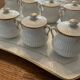 Porcelain tray and 8 matching cream pots. Antique