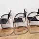 Three armchairs in black leather and steel tube