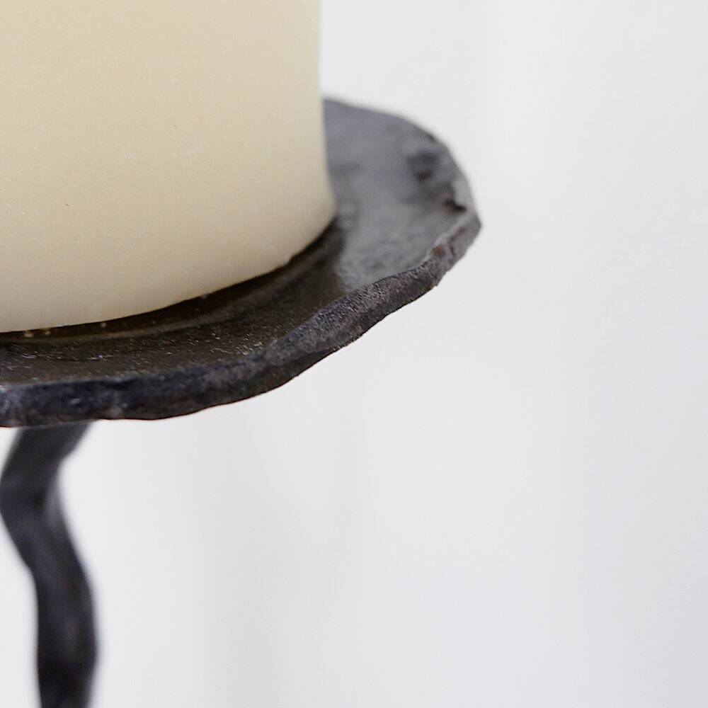 Large wrought iron candelabrum with an abstract design and three candle holders.
